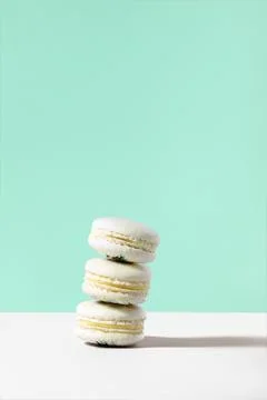 Stack of vanilla macarons against green background Stock Photos