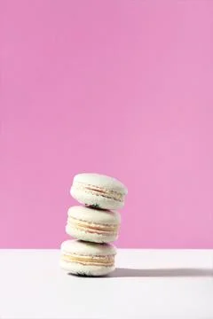 Stack of vanilla macarons on pink backdrop Stock Photos