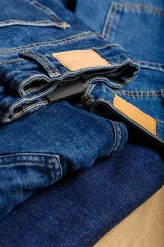 Stack of variety blue jeans, denim jean textiles as background. different blue Stock Photos