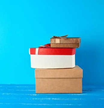 Stack of various cardboard boxes on a blue background Stock Photos