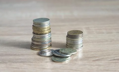 Stack of various coins on wooden background Stock Photos