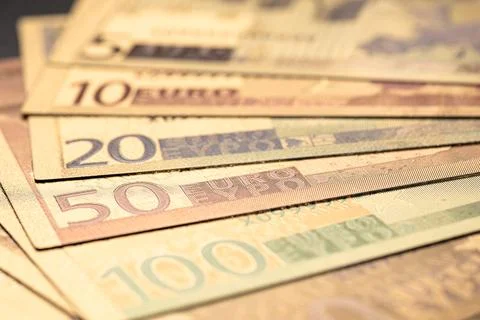 Stack of Various Euro Banknotes Arranged on a Black Background Stock Photos