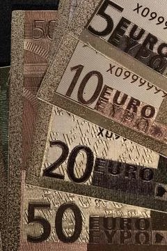 Stack of Various Euro Banknotes Arranged on a Black Background Stock Photos