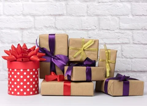 Stack of various gift boxes on white brick background Foto stock