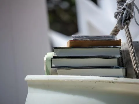 Stack of various pieces of media including books and DVDs Stock Photos