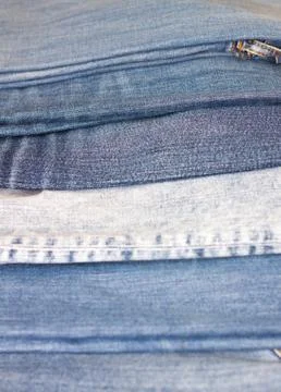 Stack of various shades of blue jeans as background Stock Photos