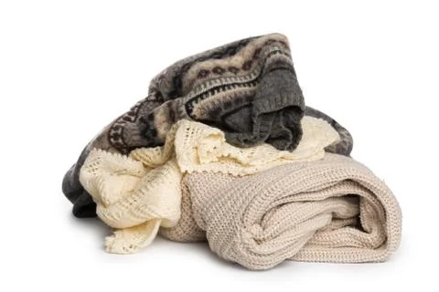 Stack of various sweaters isolated on white background Stock Photos