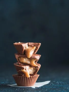 Stack of vegan chocolate cups with caramel on white 스톡 사진