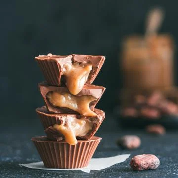 Stack of vegan chocolate cups with caramel on white 스톡 사진