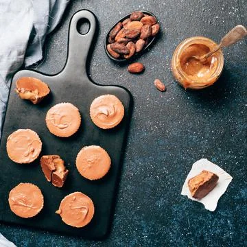 Stack of vegan chocolate cups with caramel on white 스톡 사진