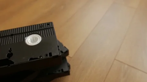 Stack of VHS video tape cassette over wooden background, top view Stock Footage 75612863