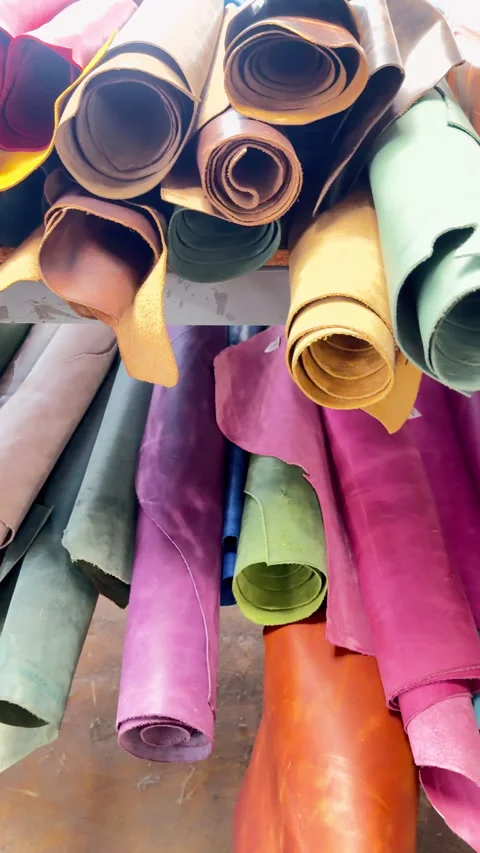 Stack of vibrant colored leather hides in workshop Video stock 344907499