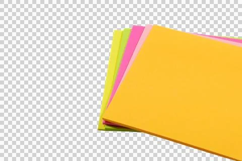Stack of vibrant neon-colored paper sheets in yellow, pink, and lime green. Stock Photos