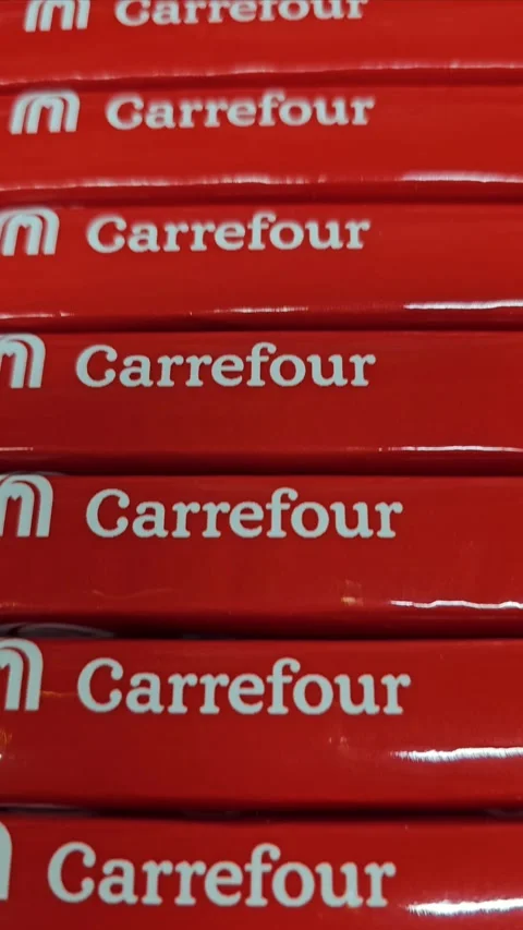 A stack of vibrant red Carrefour branded boxes, featuring the white logo Stock Footage 311765136