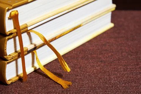 Stack of vintage hardcovered books with bookmarks on a bookshelf Stock Photos