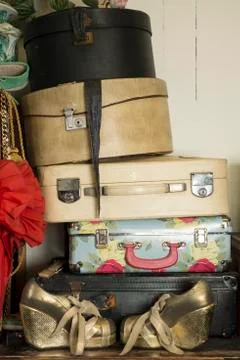 A Stack of Vintage Suitcases and a Pair of Golden Shoes Stock Photos