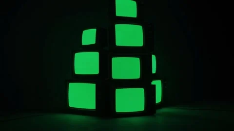 Stack of Vintage TVs with Green Screen in Dark Studio Stock Footage 313114599