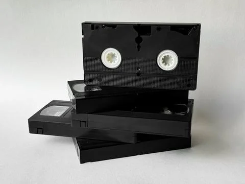 Stack of vintage vhs tapes on a white background highlighting retro media Stock Photos