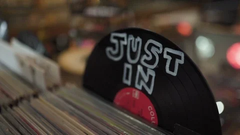 A stack of vinyl record albums in a record store with a sign "Just In" Stock Footage 106434324