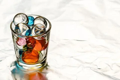 The stack for vodka is filled with hydrogel balls of different colors Stock Photos