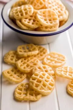 Stack of Waffle Potato Chips and Crisps on White Tabletop Snack Platter. Stock Photos