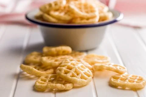 Stack of Waffle Potato Chips and Crisps on White Tabletop Snack Platter. Stock Photos