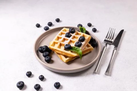 Stack of waffles with blueberries and powdered sugar 스톡 사진