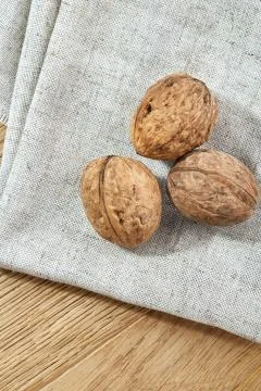 A stack of walnuts piled together and on rustic wooden background, shallow depth Stock Photos