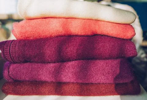 Stack of warm cashmere sweaters in color variety as spring cleaning or winter Stock Photos
