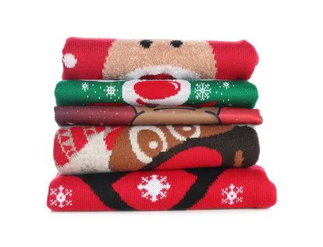Stack of warm Christmas sweaters isolated on white Foto stock