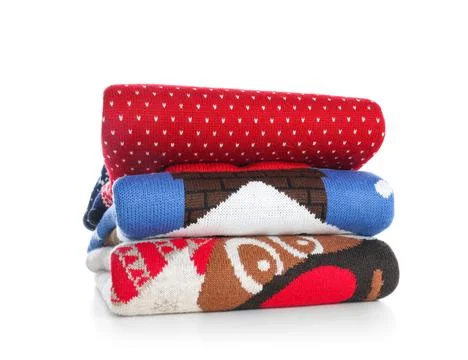 Stack of warm Christmas sweaters isolated on white 스톡 사진