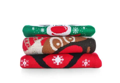 Stack of warm Christmas sweaters isolated on white Foto stock