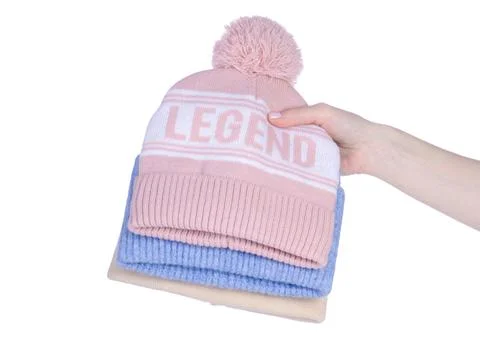 Stack of warm hats in hand Stock Photos