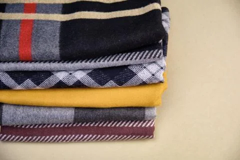 Stack of Warm knitwear close-up. Woolen knit texture as background Stock Photos