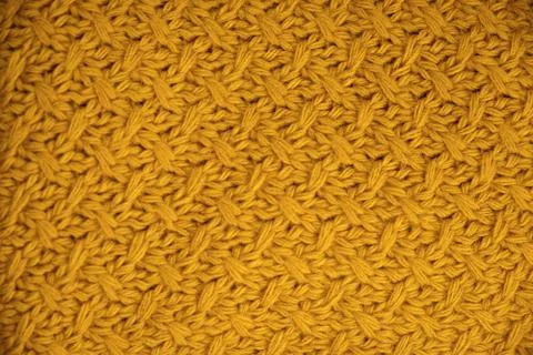 Stack of Warm knitwear close-up. Woolen knit texture as background Stock Photos