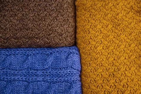 Stack of Warm knitwear close-up. Woolen knit texture as background Stock Photos