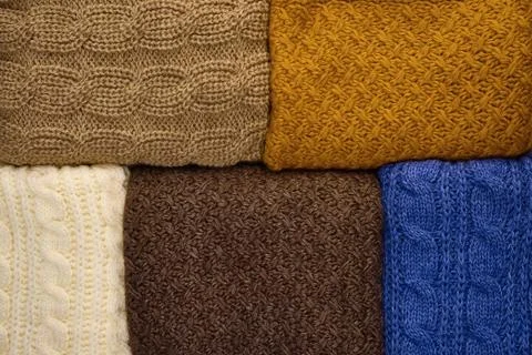 Stack of Warm knitwear close-up. Woolen knit texture as background Stock Photos