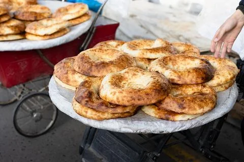 Stack of warm sesame round breads on market cart at Siab bazaar, closeup.  .. Stock Photos
