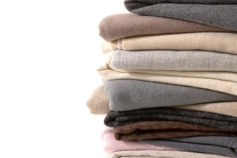 Stack of warm winter knitted cashmere on white background Stock Photos