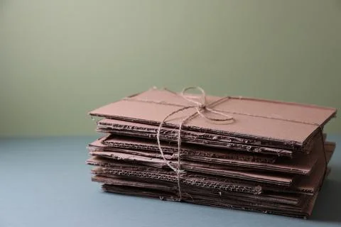 Stack of waste paper on grey table, space for text 스톡 사진