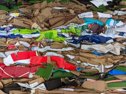 A stack of waste paper from pressed cardboard boxes. Waste sorting and recy.. Stock Photos