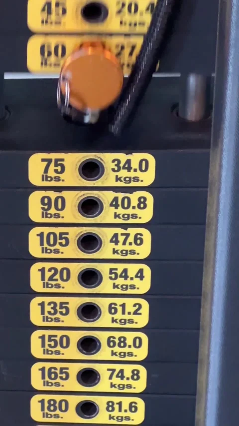 Stack of weights moving from exercise on a gym weight machine Stock Footage 285419862