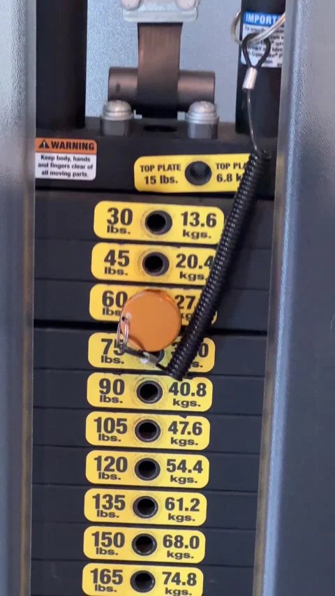 Stack of weights moving from exercise on a gym weight machine Stock Footage 285419874