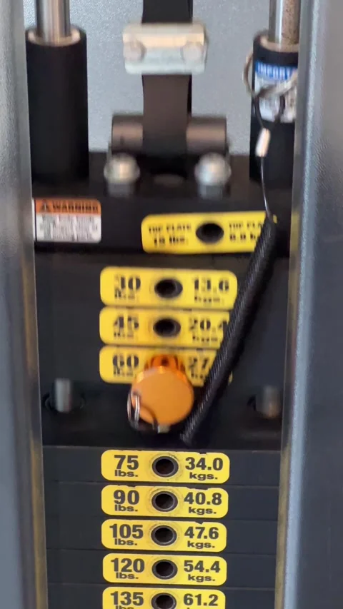 Stack of weights moving from exercise on a gym weight machine Stock Footage 285419933