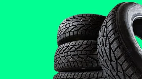 Stack of wheel new black tyres for winter car driving isolated on colored Stock Photos
