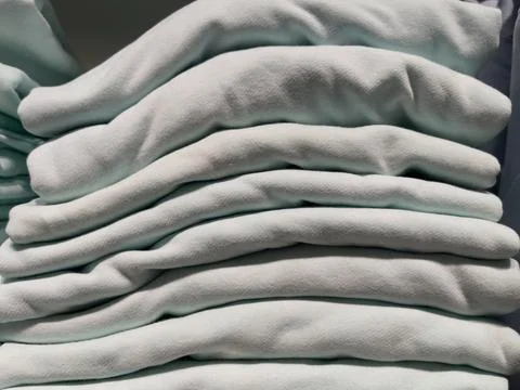 Stack of white and grey clothes on a shelf in the store. Stockfoto's