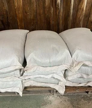 Stack of the white bags at warehouse 스톡 사진