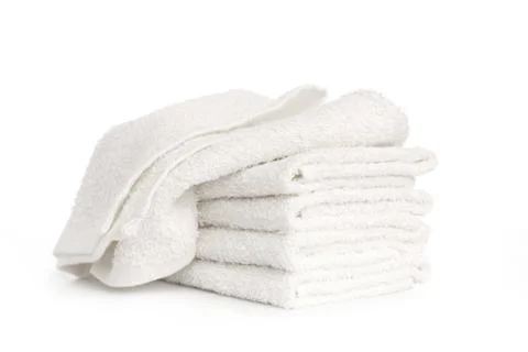 Stack of white beach soft towels folded on white background Stock Photos