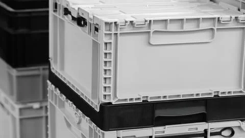 Stack of white boxes with black handles. The boxes are stacked on top of each 스톡 사진