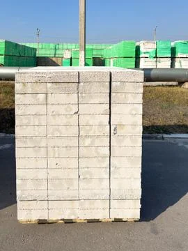 A stack of white bricks is sitting on a pallet Stock Photos
